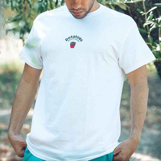 Man wearing a white t-shirt with a 'potatoes 99% of my will to live' and French fries graphic outdoors